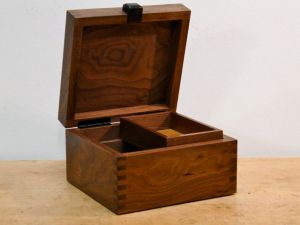 Black Walnut with Ebony lid lift and a sliding tray.